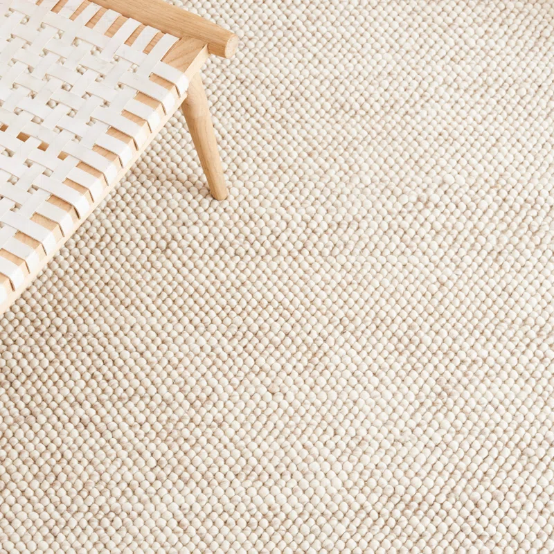textured wool rug with soft neutral tones