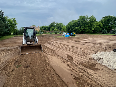 Skid steer and excavation contractor grading backyard for drainage, landscaping and sod preparation in the GTA