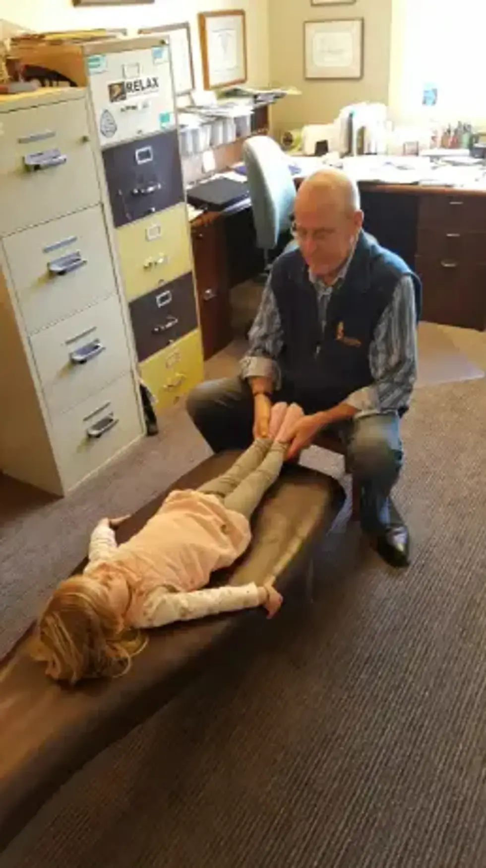 Dr. Bob checks the leg length of a young patient.