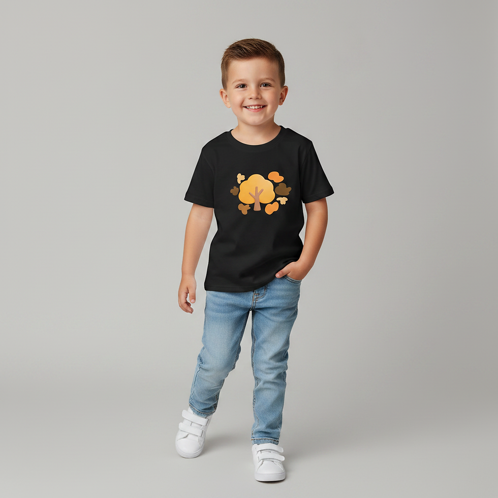 Child model standing and smiling while wearing a black t-shirt with an autumn tree graphic.