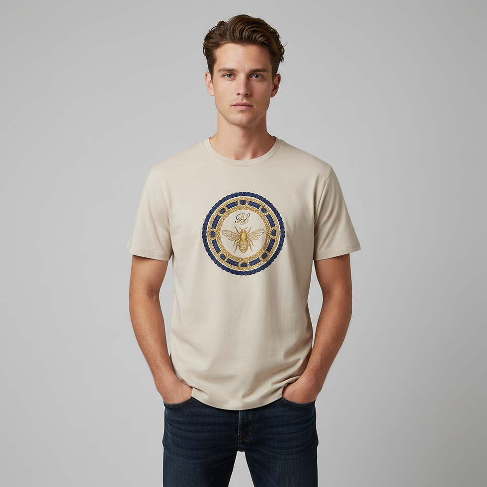 Male model wearing beige Bee Crest T-Shirt with decorative bee crest artwork