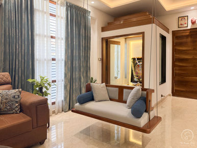Traditional indoor swing design India with blue and white pillows