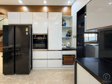 Minimalist modular kitchen design India with oven and white storage units