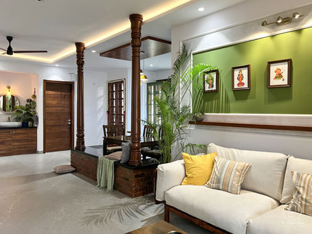 Modern living room layout India with wooden column partition and greenery