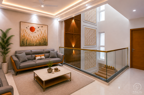 Luxury upper-floor lounge with modern gray seating, glass railings, decorative wall art, wooden accent panels, and sophisticated contemporary home interiors