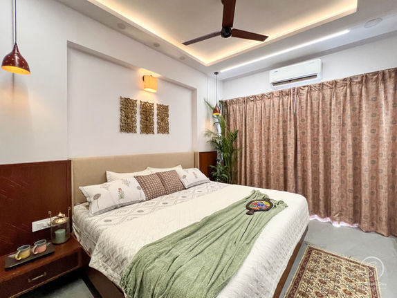 Modern bedroom design India with light wood paneling and comfortable bed