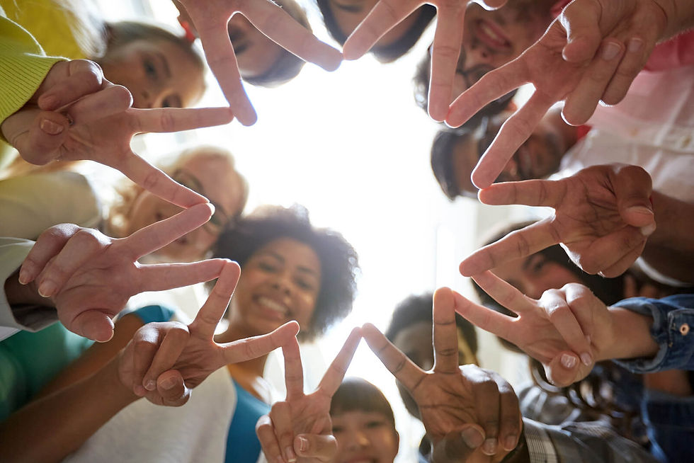 Image of a group of smiling teens standing in a circle with their fingers together forming a shape | therapy for teens in manhattan, ny | teen therapist in manhattan, ny | online therapy for teens | anxiety in teens | teen depression | 10023 | 10028 | 10013