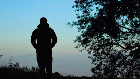 Silhouette of a man standing with his back to the camera, representing introspection supported by South Asian therapy for toxic guilt in NYC | therapy for toxic guilt nyc - south asian therapy for toxic guilt nyc - toxic guilt nyc