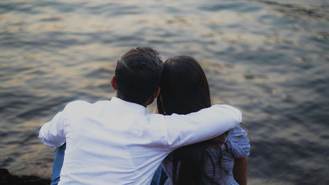 Couple leaning on each other by the water, symbolizing connection and intimacy nurtured in south asian therapy for dating in NYC | south asian therapy for dating nyc - south asian mental health nyc - south asian therapy nyc - new york city