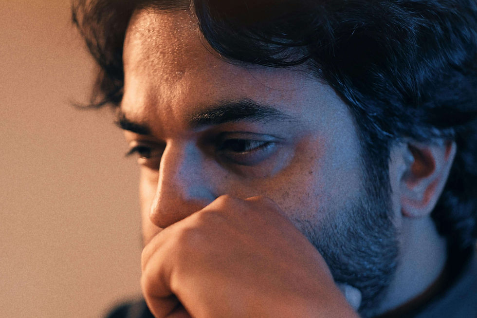 Close-up of a man deep in thought, representing self-evaluation explored in South Asian therapy for low self-esteem in NYC | therapy for low self esteem nyc - south asian therapy nyc - south asian therapist nyc