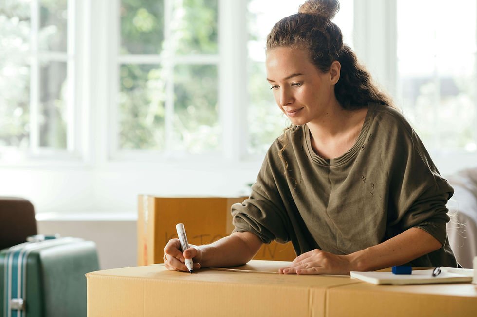 Woman writing on a cardboard box with a marker in a bright room | life transitions in NYC | anxiety therapy | high functioning anxiety | Brooklyn Heights | West Village | Greenwich Village
