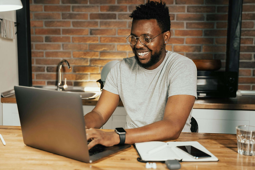 Man smiling and typing on a laptop in a kitchen with brick walls | executive functioning skills for adults in boulder county, co | executive skills coaching | executive skills coach |
Arapahoe | Foothills | Boulder