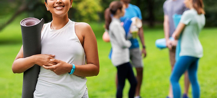 A woman smiles while holding a yoga mat in front of other people | Therapy for Self-Esteem and Confidence in Des Plaines, IL | Self-Esteem and Confidence in Des Plaines, IL | Self-esteem therapist in Des Plaines, IL | Low Self-Esteem in Des Plaines, IL | 60203 | 60657 | 60622 | 60607 | 60053
