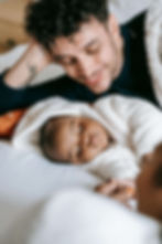 A tender moment between a parent and their sleeping baby, symbolizing the importance of therapy for dads in Des Plaines, IL, and support for postnatal depression in men in Des Plaines, IL. Golf Terrace, IL | Park Ridge, IL | Arlington Heights, IL