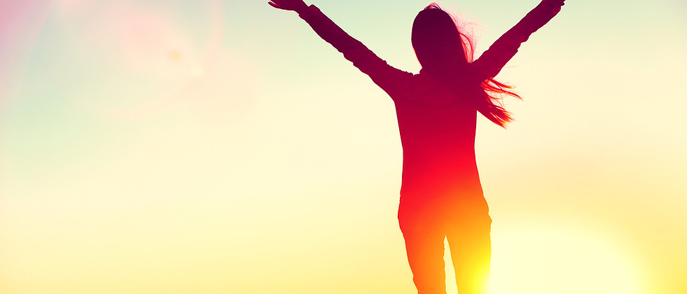 Happy individual lifting arms facing sun | acceptance and committment therapy in Madison, WI 53703 | ACT therapy | ACT Hexaflex | ACT mindfulness | Mindfulness therapy