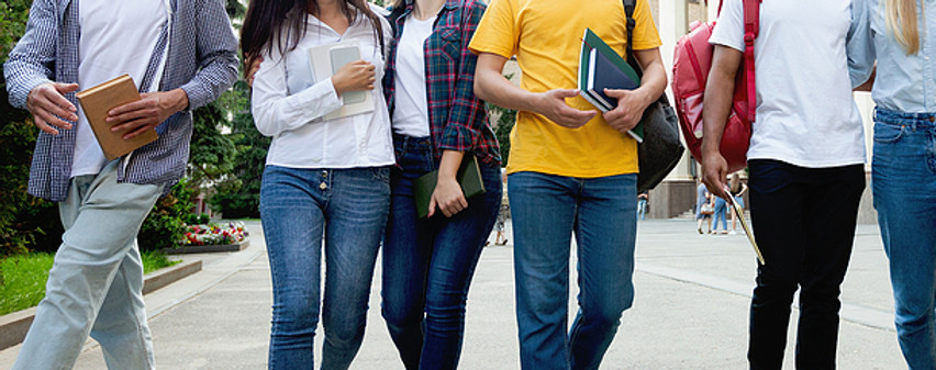 Group of teens carrying books on their way to classes | therapy for teens | adolescent therapist in madison, wi 53703 | online therapy | child therapist | madison therapists | 53202 Milwaukee | 54311 Green Bay