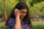 South Asian woman standing outdoors in quiet reflection, representing the emotional awareness and healing explored in South Asian therapy for strict parents in NYC | south asian therapy for strict parents nyc - strict parents nyc - south asian mental health nyc