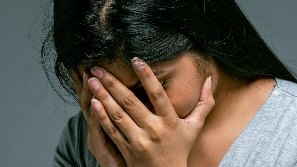 Woman covering her face in distress, capturing the pain and emotional weight often carried in silence before seeking EMDR therapy in New York for healing from sexual trauma | emdr therapy in new york - emdr south asian therapy nyc - south asian therapy nyc