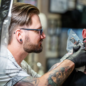Fort Collins tattoo artist tattooing a client at Linden Street Tattoo Company in Old Town Fort Collins, Colorado.