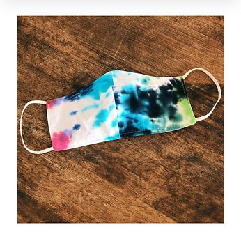 A tie dye blue, pink, and green cloth mask made by a Design Lab Give student.