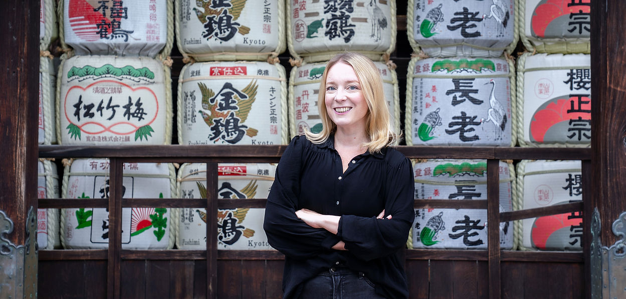 cindy bissig in front of sake barrels banner.jpg