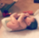 Cute baby with toes in mouth