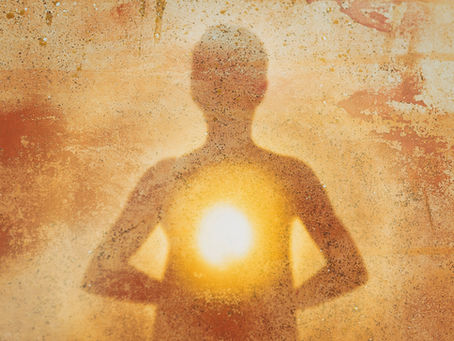 The shadow of a woman with light in her heart.