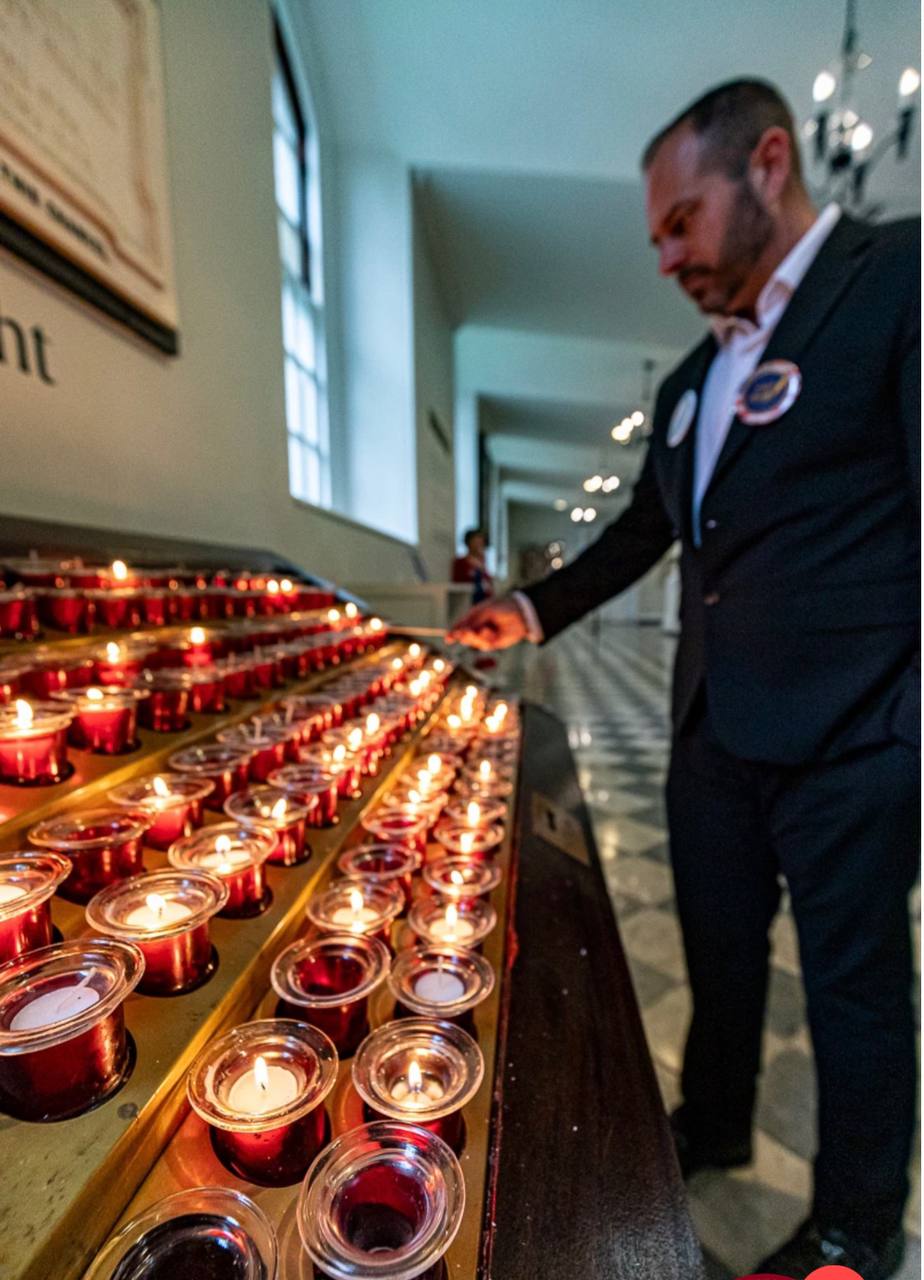 Jimmy Hayes lighting a candle for his grandfather at St. Paul's Chapel — April 30, 2026