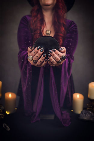 Amy The Kitchen Witch holding a crystal ball during an astrology reading