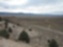 High-angle view of a vast, arid desert landscape.