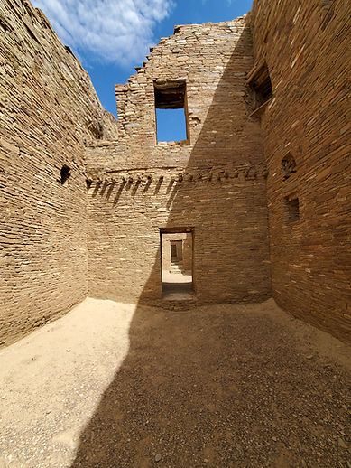 Ancient stone ruins with doorways and clear blue sky