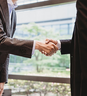 Two business professionals shaking hands to represent business law services provided by K. Nichols Law Firm, PLLC in Heath, Rockwall, and North Texas
