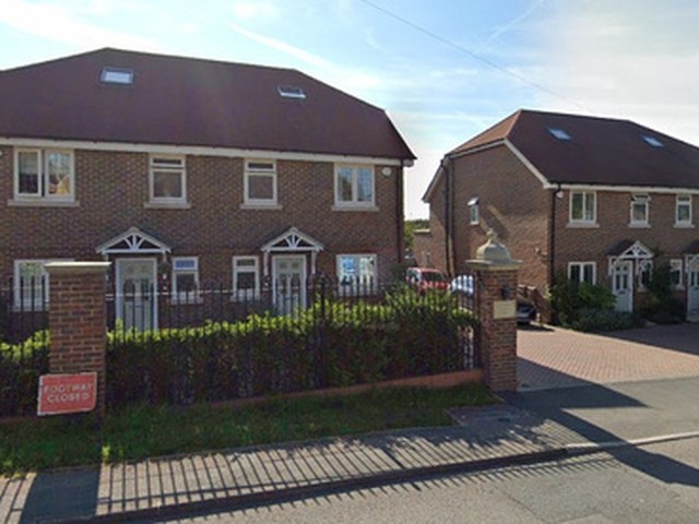 Completed pair of new brick homes on a residential street
