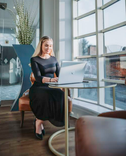 Ella Hardy, Director of Land Profits, working on a laptop