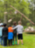 Young children observe a large sculpture in The Sculpture Garden, with trees in background.