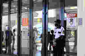 A security guard stands at the entrance of to uphold COVID-19 Protocols.