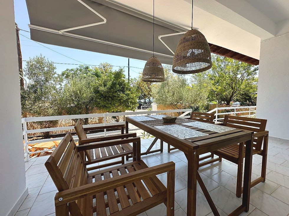 Outdoor dining area at Assamaris Beach House near the sea