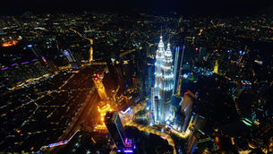 Kuala Lumpur skyline at night with high-rise buildings and affordable property areas in KL