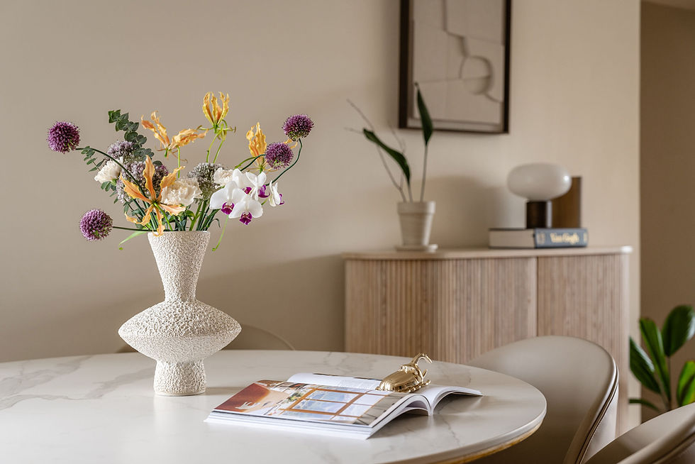 Uniquely shaped vase with flowers in dining room