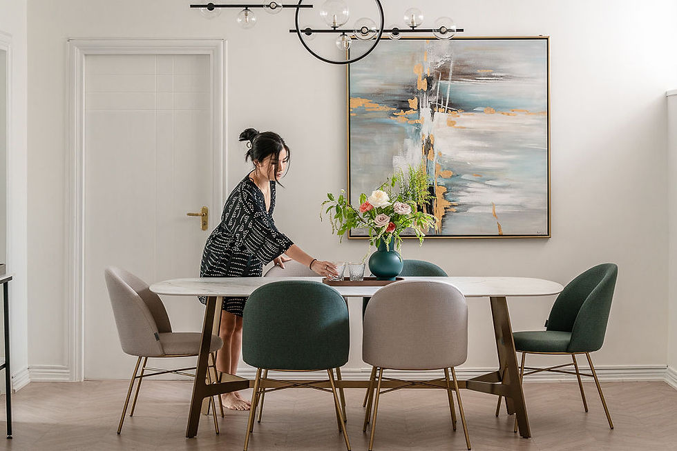 Lady setting dining table with flower vase