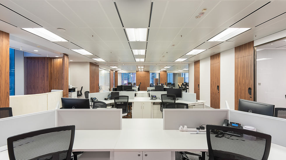Corporate office with white desks and wood wall accents