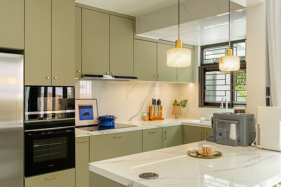 Modern kitchen with olive cabinets, white marble counters, and pendant lights. Features a blue pot, art, knife stand, and coffee cup. Bright mood.
