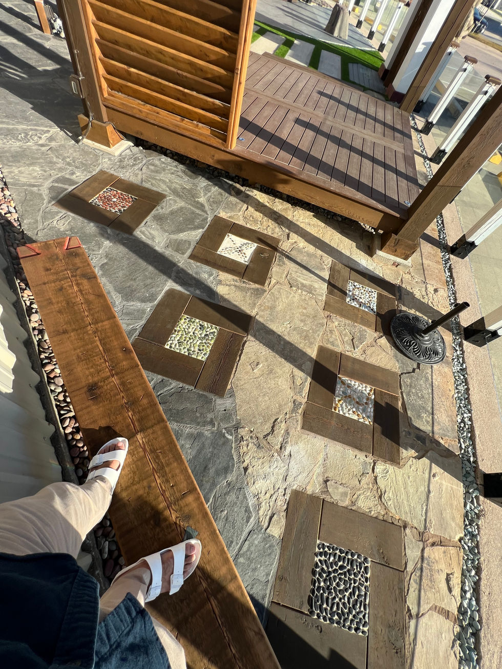Pebble and stone inlay band between paver sections