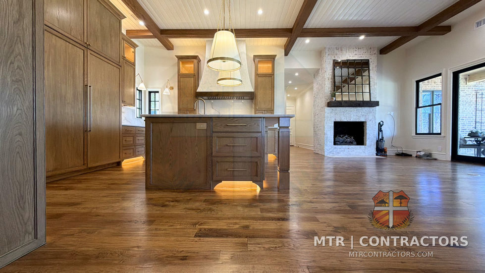 Kitchen opening to the keeping room with exposed timber beams overhead — kitchen remodel in Little Elm, TX by MTR Contractors of Frisco
