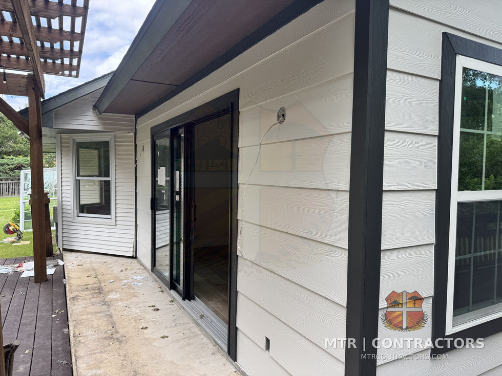 Living room addition exterior with black-frame sliding glass door and — whole-home remodel by MTR Contractors, Frisco TX