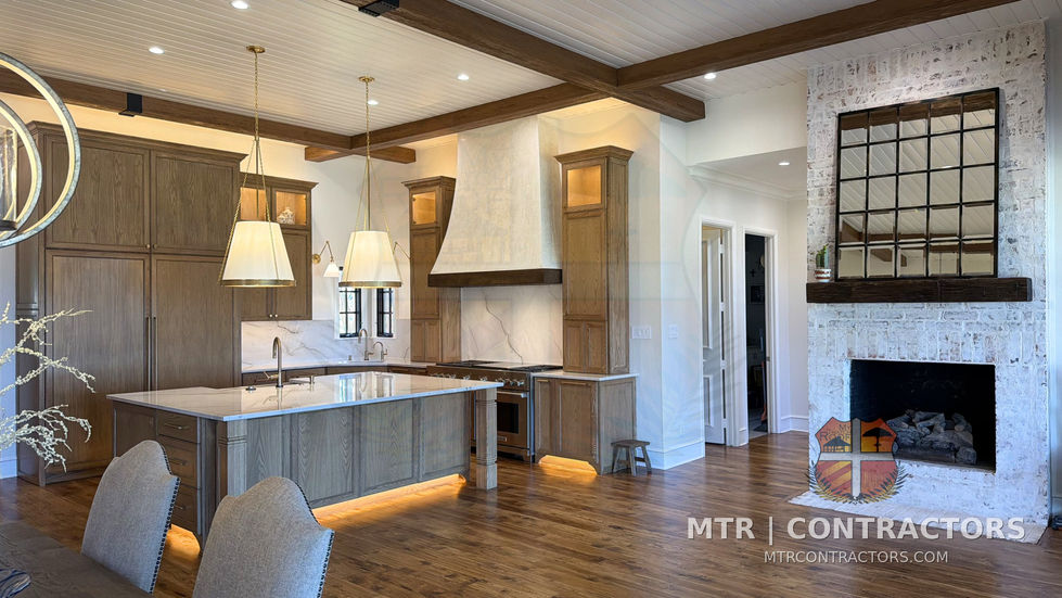 Remodeled kitchen and keeping room with quartzite island, wood hood and stone — kitchen remodel in Little Elm, TX by MTR Contractors of Frisco