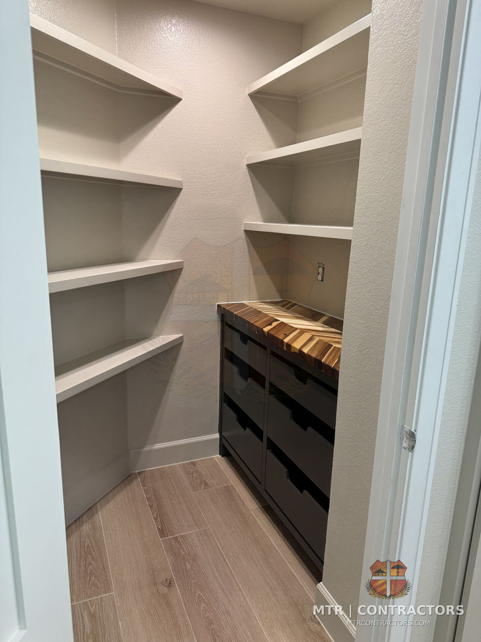 Walk-in closet built-ins with shelving and drawer tower — whole-home remodel by MTR Contractors, Frisco TX