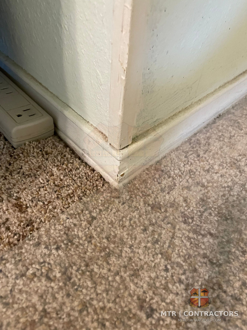 Existing carpet and baseboard at the bathroom entry — bathroom remodel by MTR Contractors, Frisco TX