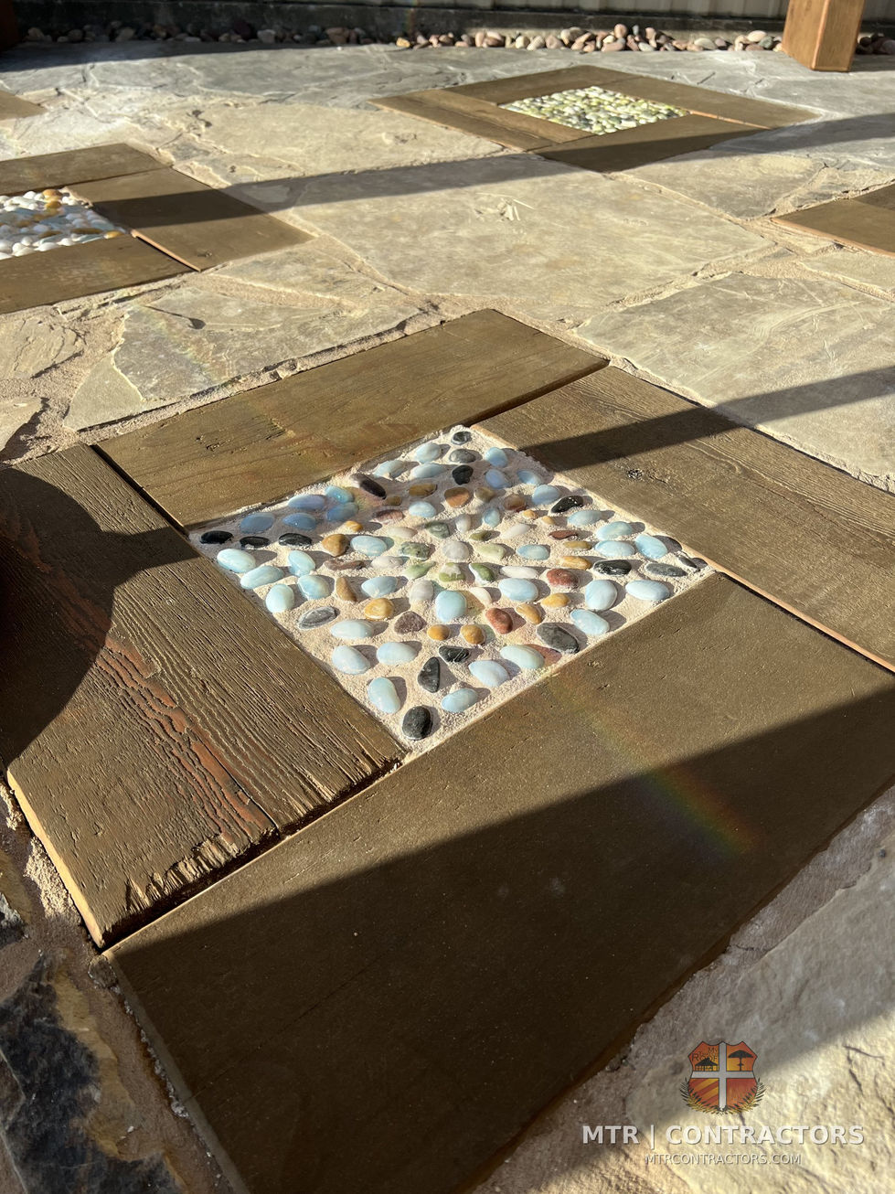 Mixed material flooring panels laid side by side for comparison — outdoor living showroom in Frisco, TX