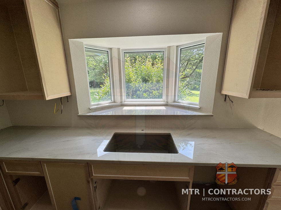 Bay window over the cooktop with new quartz counters — whole-home remodel by MTR Contractors, Frisco TX